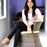 Amritha Aiyer, rose colour dress, chair, sit