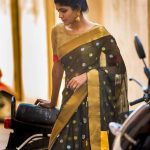 Niranjani Ahathian (9) green saree standing by bike