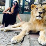 natasha suri in black dress with lioness