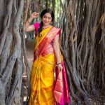 ramya vj in yellow silk saree flowers traditional look pose with pink blouses banyan tree