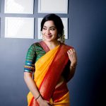 ramya vj in yellow silk saree jasmine flowers traditional look front pose with green blouse