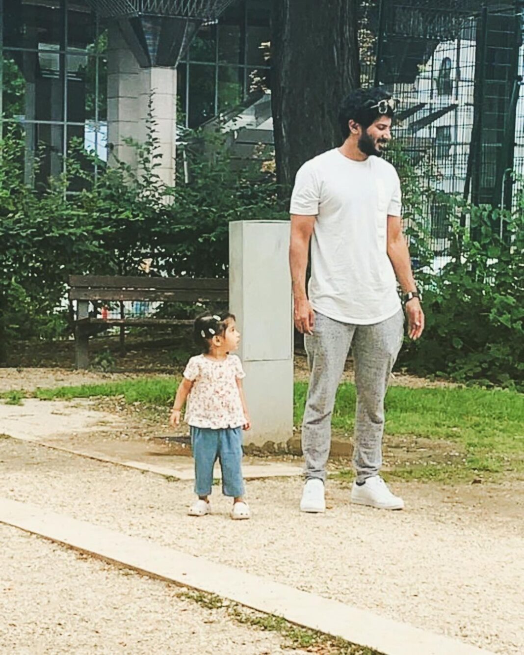 Dulquer Salmaan Instagram - We even stand the same !!! 📸 Ms Mamma #likefatherlikedaughter #twinningwithM #pigtails #floppyhair #minime #playarea #or #pyay #ayea #herfavthing #outdoorsy #parks #slides #swings #merrygorounds #dQnAnM #heart #vacay #budapest