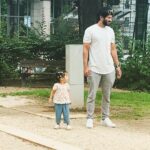 Dulquer Salmaan Instagram - We even stand the same !!! 📸 Ms Mamma #likefatherlikedaughter #twinningwithM #pigtails #floppyhair #minime #playarea #or #pyay #ayea #herfavthing #outdoorsy #parks #slides #swings #merrygorounds #dQnAnM #heart #vacay #budapest