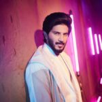 Dulquer Salmaan Instagram - More where that came from ! #leanback #neonlights #dontgetthatoutfitdirty #leanbutdontlean #wierd #balancingact #intensegazefail #stillkeeptrying #layeredintheheat #imhotcauseimboiling #hairsituation White suit : @sanchit_baweja White colour block hoodie : @topshop Styled by : @abhilashatd Assisted by : @dipteeagarwal Images : @vaishnavpraveen @thehouseofpixels
