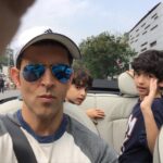 Hrithik Roshan Instagram - Smile boys! Eyes on the road, Dad. #schooledbymychildren #cruisingthestreets #convertiblesarecool