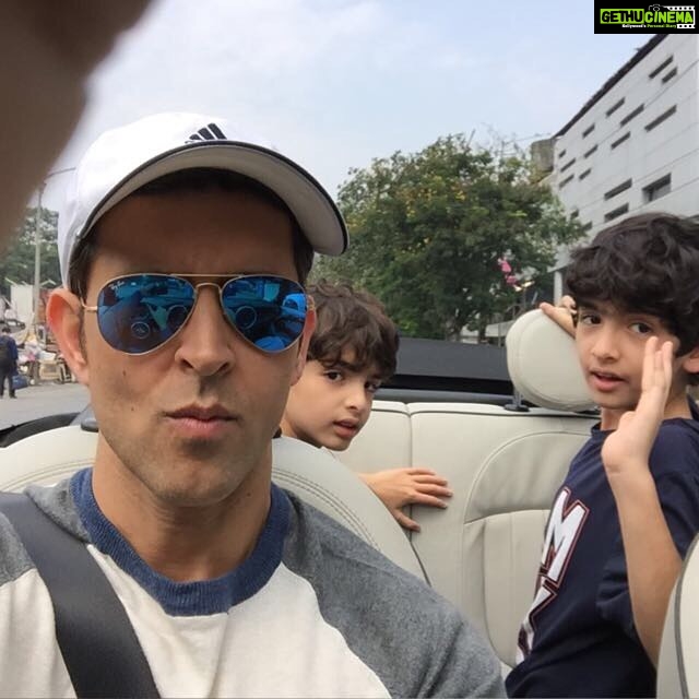 Hrithik Roshan Instagram - Smile boys! Eyes on the road, Dad. #schooledbymychildren #cruisingthestreets #convertiblesarecool