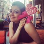 Kajal Aggarwal Instagram – #Asweetendingtoanewbeginning :) enjoying this candy gifted very sweetly by a complete stranger #itsthelittlethings #randomgestures #poland 🍭🎀💜