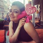 Kajal Aggarwal Instagram – #Asweetendingtoanewbeginning :) enjoying this candy gifted very sweetly by a complete stranger #itsthelittlethings #randomgestures #poland 🍭🎀💜