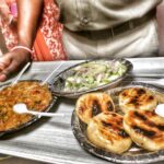 Lisa Ray Instagram - First taste of #Patna's renowned #LittiChokha Delicious dough balls stuffed with chickpea flour, roasted over a coal fire and accompanied by a veggie purée My question is...where can I find this outside of Bihar? #littichokha #Patna #yum #incredibleindia @rado