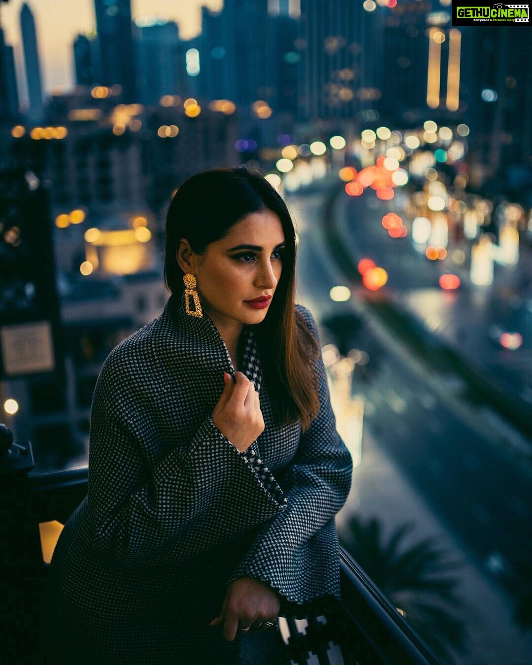 Nargis Fakhir Instagram - City living. 🌃 What city do you feel most at home in? . . . . . . . Photog @kashifrashid . Mua & Hair @malihajkhan . Styled by @rubyalgayar . Coat by @dinazakiofficial . Coordinated by @mahakbrahmawar . . . . #healthiswealth #womensupportwomen #bossbabe #powerofshe #citylife #cityscape #moodyports #portraits_ig #hudabeauty #makeupblogger