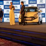 Natasha Suri Instagram – Hyundai’s ‘All New Santro- India’s Favourite Family Car’ is back again on Indian roads in all its glory!! Had such a wonderfully successful launch show with the oh-so-charming @iamsrk !! My outfit by @asbaabofficial 
#natashasuri #shahrukhkhan #hyundai #allnewsantro
