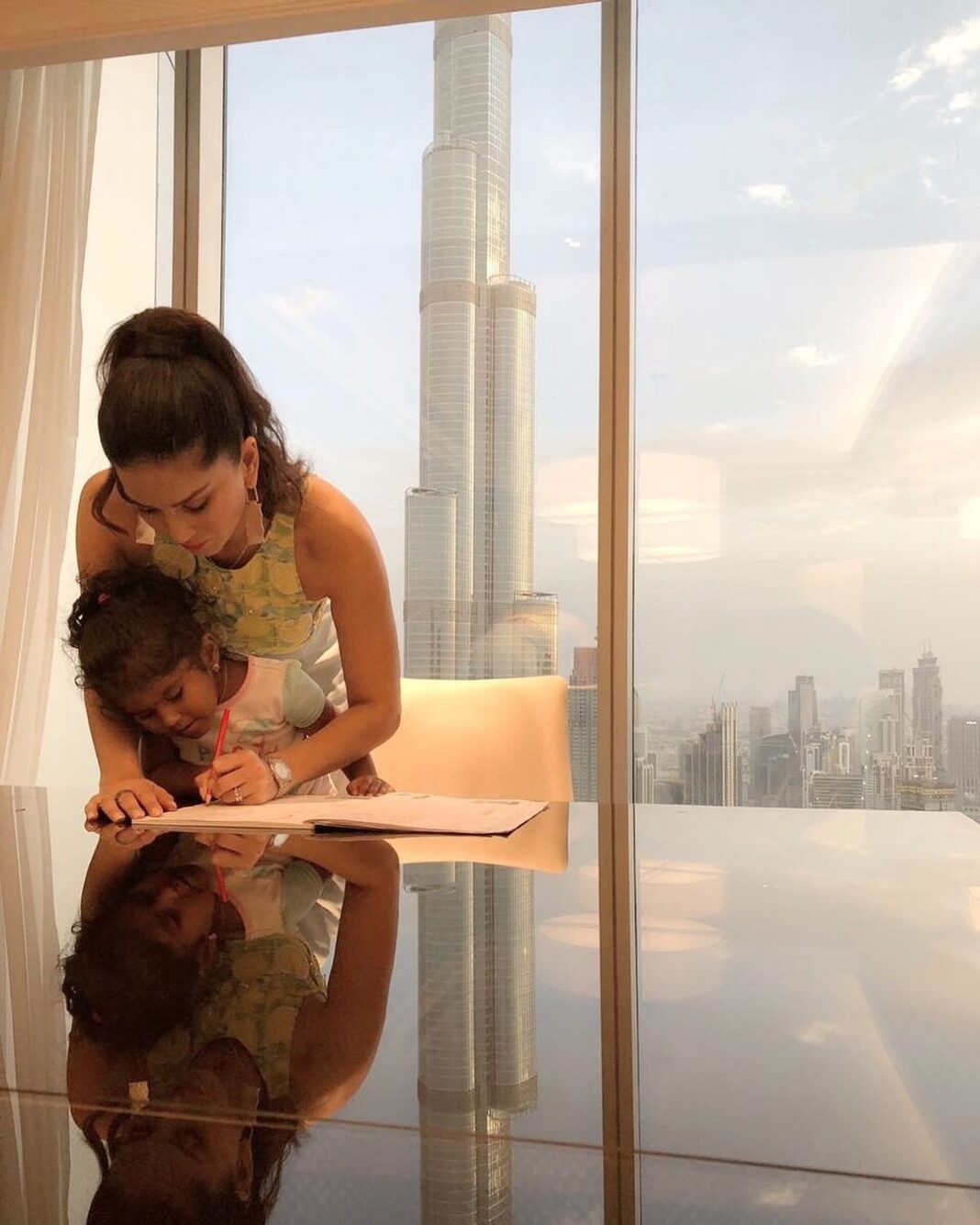 Sunny Leone Instagram - On vacation but I believe in consistency with my daughter. Helping her finish the homework assignment I set for her :) Beautiful Burj Khalifa in the background!! Dubai, United Arab Emirates