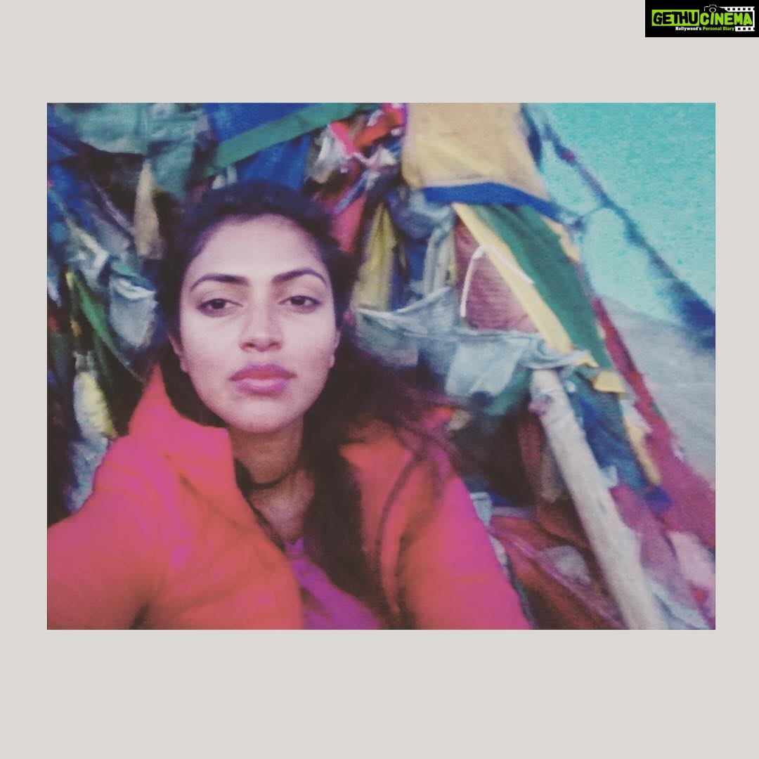 Amala Paul Instagram - Cold breeze and a gypsy soul, when two combine magic happens!! Some magic from the mountains ⛰ #throwback #himalayas #mountaingirl #gypsysoul #lehladakh #ommanipadmehum #prayerflags