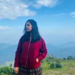 Angana Roy Instagram - Dear mountains, I think about you every now and then. 📸@shieladitya_official #throwback #mountains #mountainview #majormissing #hills #creativelifehappylife #mountainstories #hillshaveeyes #red #jacket #skirtandtop #blueskies #picturesque #naturephotography #naturelover #sittong #kurseong #travelphotography Sittong-Shelpu-Latpanchor