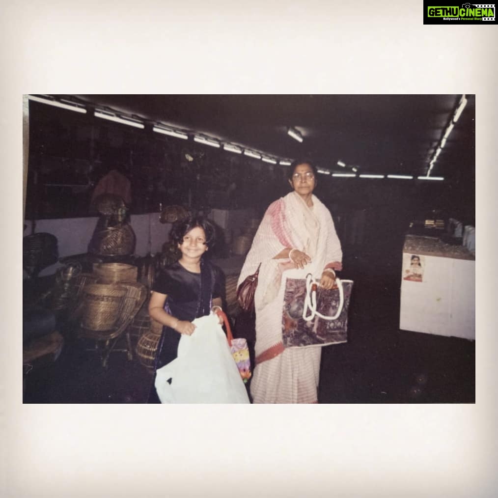 Angana Roy Instagram - Yesterday. You left us four years ago, yesterday. I couldn't bring myself to do anything yesterday, let alone post anything on social media. This picture was taken by my mother sometime in 2004, probably in Summer. We went to this exhibition in Dakshinapan where wooden and handmade pieces were being sold. Bouma's love for jute bags and my love for camera is evident here. Bouma never liked to be photographed much, this is one of the few pictures where she didn't object. I remember sporting this short hair back then and wearing this dress ever so often. Oh, and as it's evident from the picture, I would never leave my Bouma's side, ever. She brought me up in Asansol along with my Doo. While scrolling through your pictures in the 'People and Places' section of Google Photos, I stumbled upon this picture. It's not a picture of great significance as it was clicked quite randomly, but I wish to post this for the same reason. I find this picture to be from simpler, happier times of my childhood. তুমি রবে নীরবে হৃদয়ে মম। - রানী #memories #memoriesforlife #nostalgia #grandmother #happiertimes #missing #missher #december2020 #nolovelost Dhakuria