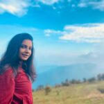 Angana Roy Instagram - Dear mountains, I think about you every now and then. 📸@shieladitya_official #throwback #mountains #mountainview #majormissing #hills #creativelifehappylife #mountainstories #hillshaveeyes #red #jacket #skirtandtop #blueskies #picturesque #naturephotography #naturelover #sittong #kurseong #travelphotography Sittong-Shelpu-Latpanchor
