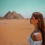 Aparnaa Bajpai Instagram - Overlooking the magnanimous piece of art aligned & geometrically designed with specific details & perfection in an era when humans were limited to only hand tools and equipments.🌞🌔 Wow!! • Ps: just took a breath to soak in the ancient vibe💫 . . . #travel #travelphotography #travelblogger #travelvlogger #travelbucketlist #travelgram #roamingaffair #sonyalpha #lightroom #egypt #pyramids #pyramidsofgiza #giza #spinx الهرم Al Haram