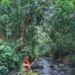 Aparnaa Bajpai Instagram - #Repost @roamingaffair ・・・ Our Jungle Book!! We walked down a long trail to find this river, hands tightly gripped together so neither of us fall down. I felt like Mowgli and he was my Baloo. He looked at the big rock and grabbed the camera. Following his command I jumped on the rock. I looked around when he captured the perfect moment. Then we shared a few laughs where he joked, maybe he should float down the river with me sitting on his belly singing bear necessities. Even out there, secluded in the bamboo forest, it is possible to have blood rush to our Indian cheeks at the very thought of being close in public. As Kipling put it, "Man is the only animal that blushes, or needs to." #bali #ubud #traveller #glocalchild #blogger #sonyalpha #travel #travelbucketlist #travelholic #travelgram #travelshot Bali, Indonesia