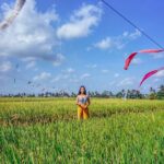 Aparnaa Bajpai Instagram - #Repost @roamingaffair ・・・ Rice paddy fields🤩 Bali is embellished with beautiful stretch of rice fields in every other location and it is not difficult to witness this beautiful and vivid display of nature, in every kilometer you drive to. We actually were riding to a nearby chemist to find a sunburn medication and belive you me, I was in pain cuz this little 🌞 of a burn was hurting and itching like crazy and not only we had been driving and and spotting rice fields every where we had been in bali but also we had entered clicked pictures, and sat in a wonderful cafe right in the center of rice pad and had delicious coconut water. So basically, we had enjoyed and assimilated the gorgeous field of vision in its entirety. But but but... this beautiful location didn't fail to impress aadar at all and infact he saw something more attractive in the way these flags were swaying with the wind. And like a perfect photographer companion, he stopped the bike and said: 'Look..... I want you to walk in there and stand at that exact spot and you see those flags and you see the sky' and this and that and an entire lala land story to finally convince me to forget my excruciating pain for a few mins to let him click this picture... I don't know about y'all but for me, this picture certainly has a beautiful and kind of a painful😭 story behind it and I totally & completely love this picture😍 Let us know how do you guys feel about this picture. Also, I kind of over exaggerated my pain :p sorry🤐 #bali #traveller #travel #blogger #glocalchild #sonyalpha @sonyalpha #knowbali #travelbucketlist #travelholic #travelgram #travelshot #mytravelstories Bali, Indonesia
