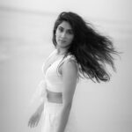 Deepti Sati Instagram - The Waves whisper sonnets for her, Calling her to the soft sandy beach, Cleansing her feet with the salty water of life 🌊 Shot by : @sathyan_rajan Location : @tripislife Creative Director : @milanmaliackal MUA: @rizwan_themakeupboy Line Producer: @mithzmathew Fashion tape: @adhs_98 Outfit : @image_.boutique