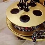Navya Nair Instagram - Birthday surprise by @myowns_p_a_c_e and jabeen … @themistledough the yummiest cake evn wen made with such a theme and all .. such a thoughtful idea jabeen and evn my kid had asked me , “did u really acted in so many movies mamma “ 😂😂😂 one portion was biscoff and the other was yummy praline chocolate.. Jabeen ur cakes r my all time fav … keep rocking …