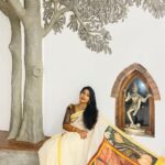 Navya Nair Instagram – Thank u so much @sreerani_online  fr this beautiful@painting and hand painted mural saree .. 

Accessories @chinkaari_collections 

*The Saree* 
The painiting is of Padmapani Bodhisattwa from the paintings of Ajanta caves. A good amount of exploration was done to get the authentic paintings. The human components and most of the other components in the painting except for the ornaments were painted using faded out approach. This was to bring out the grandeur of the ornaments and still give the painting an antique look. Painted using fabric acrylic paints. The size is 26″X40″. The painting is done on Special handwoven Balaramapuram Sreerani saree series. The yarn used is 100% best quality Unakku Pavu cotton yarn. This is further enriched with 3 inches bold Golden colour Kasavu on the Mundani/Pallu. Priced at Rs. 20,400.

*The Wall Painting* 
The painting is from the Ajantha caves and is of Prince Siddharth having a worldly life with lot of people posted to attend to him and serve him so that he doesn’t come across the realities of life like hunger, old age etc. The Artist has endeavoured and has accomplished to the bring the antique and worn out look in the painting by employing the Wash & sponging techniques using the water colour method. Professional quality Winsor & Newton’s Acrylic medium to ensure long lasting colour quality. The painting is done in 3 pieces of canvas 2 measuring 25″ X 50″ each which goes on both the sides of a 50″X50″ middle piece. Priced at Rs. 1,44,000.