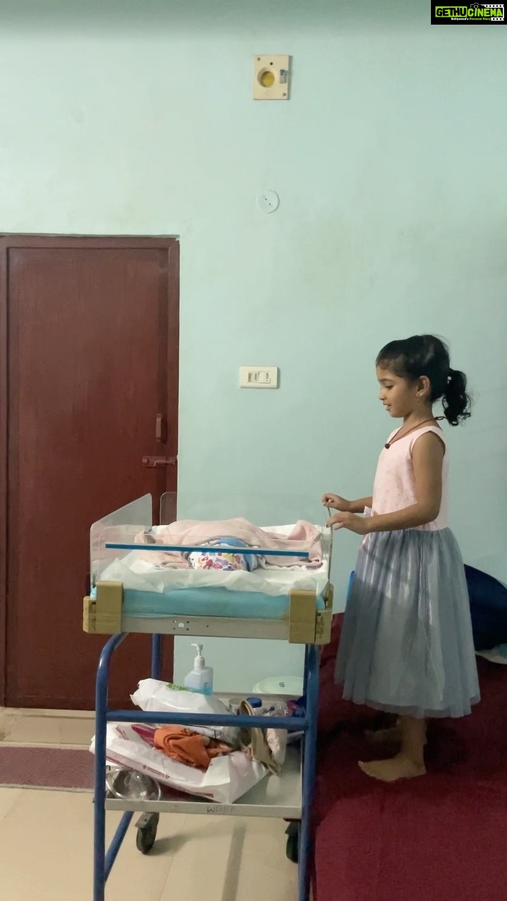 Neelima Rani Instagram - On Jan 5th when papa was brought into my room from the operation theatre,first thing Aditi did was this!! She sang a lullaby and made sure her thangachi is happy! Such a warm moment for me to watch as a mom! Treasures for life π #siblings #sisters #daughter #mom #parenting #happy #love