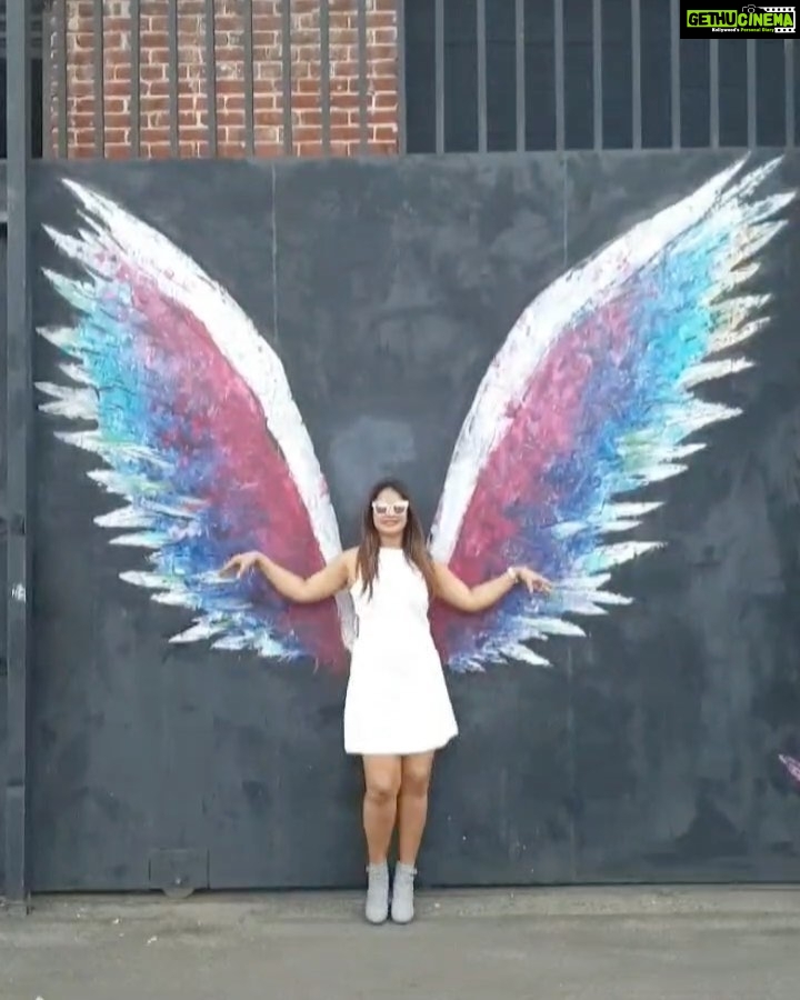Neetu Chandra Instagram - Happy to have stumbled upon this visual treat!β£οΈ This amazing graffiti scattered across the town leaves me amazed! π¨ Wish we had wings so that we could soar through the skies! πΌπ« #art #graffiti #angelwings