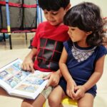 Sameera Reddy Instagram - Story time! Fills my heart to see my lil Buddy read to my Babygirl. See how attentively she listens.. #fatherhood #familygoals