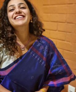 Nithya Menen Instagram - Tangaliya or Daana weaving 🧵  from Gujarat is mainly practiced by the Dangasia community. It's history spans back over 700 years ! :) 🕰 

 The legend goes, that a young man from the shepherding community of Bhadwad , fell in love with a young lady from a neighbouring weaving community🧶 and married her .  His family disapproved of the match, and the young couple were made unwelcome. So they settled with her family of weavers and he continued to herd sheep. As he learnt the craft of weaving, he started to use the wool from his sheep 🐑  and thus the art of Tangaliya weaving came into being !  Within the Dangasias and Bhadwads communities, no special occasion was complete without draping or gifting tangaliya weave 

This craft was unknown to the world until 2007-2008, when it received the GI (Geographical Indication) certification, during the design intervention project by NIFT. The Dangasia community became well known for their tangaliya weaving. However, when the project ended the system started to lose its dynamics.

Today, with the introduction of less expensive, printed textiles in the market, many traditional weavers and their descendants are sustaining themselves by working as labourers in factories and farms or migrating to the cities in search of working opportunities.
@isha.savetheweave 
Thank you @lakkarajusailaja for letting me wear your mothers necklace🤎🤎 😊