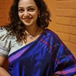 Nithya Menen Instagram - Tangaliya or Daana weaving 🧵 from Gujarat is mainly practiced by the Dangasia community. It's history spans back over 700 years ! :) 🕰 The legend goes, that a young man from the shepherding community of Bhadwad , fell in love with a young lady from a neighbouring weaving community🧶 and married her . His family disapproved of the match, and the young couple were made unwelcome. So they settled with her family of weavers and he continued to herd sheep. As he learnt the craft of weaving, he started to use the wool from his sheep 🐑 and thus the art of Tangaliya weaving came into being ! Within the Dangasias and Bhadwads communities, no special occasion was complete without draping or gifting tangaliya weave This craft was unknown to the world until 2007-2008, when it received the GI (Geographical Indication) certification, during the design intervention project by NIFT. The Dangasia community became well known for their tangaliya weaving. However, when the project ended the system started to lose its dynamics. Today, with the introduction of less expensive, printed textiles in the market, many traditional weavers and their descendants are sustaining themselves by working as labourers in factories and farms or migrating to the cities in search of working opportunities. @isha.savetheweave Thank you @lakkarajusailaja for letting me wear your mothers necklace🤎🤎 😊