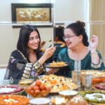 Amrita Rao Instagram - Happy Mother’s Day to all the L😍vely Moms out there! 🥂 Here's Mom & I, celebrating Her inspirational journey over a royal spread of biryanis, kebabs & desserts from the bessst we have in town @behrouzbiryani 😃😋 ✨ When most Mothers her age succumbed to societal norms, my mother broke the cliche and laid the foundation to be an independent woman. She didn’t give in to the family imposed guilt of quitting her job to look after me when I was born and resumed work just 45 days later. She was determined to strike a balance and she did! The journey wasn’t easy, but Mom made every bit of the ride worth it ! Not once did I ever feel the absence of her presence and care. Every day after school, I’d call and tell her & She’d be just a call away & not once said she was busy & could speak to me. ❤️ From sporting a boy cut hairdo then to wearing the clothes of her choice to riding a two-wheeler, mom has always done what she wanted to. She gave me the same freedom and space to be my own person and never imposed anything on me. ☺️ For someone so special, I only want to give her the bessst! 😍 Today, on Mother’s Day, I’m celebrating and saluting my Mom by treating her to a feast fit for a Queen 👑 - a royal lavish spread of mouth-watering biryani, delicious kebabs and indulgent desserts from Behrouz Biryani. Kyunki, kuch pal sirf Behrouz se khaas bante hain! #behrouzbiryani #biryani #mothersday #mothersdayspecial