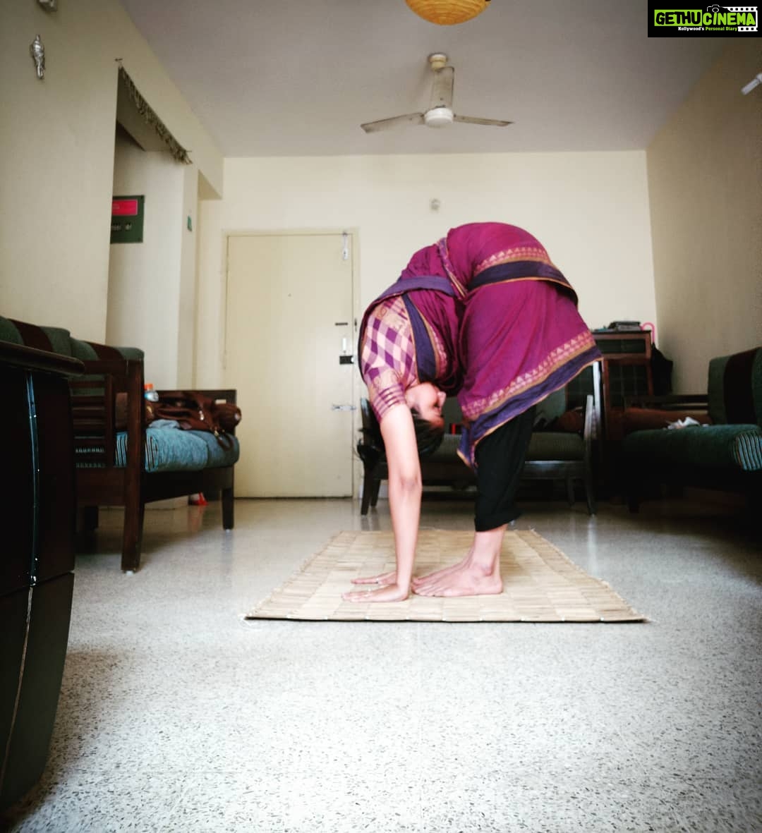 Archana Jois Instagram - A little more and I'm there! #uttanasana Obsessed with the colour and the pattern on the saree.. My dance teacher gifted this to a bunch of us back in 2013/14 maybe,.. #yogainsaree #dancesaree