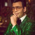 Karan Johar Instagram - Ok so it’s Christmas tree chic! But the Bling factor is intact! I am overwhelmed with the love and blessings but that didn’t stop me for being a serial poser, pouter and preener! Roz karenge pose✅ styled by @ekalakhani in @dolcegabbana hair @rajeev_gogoi make up @paresh_kalgutkar 📸 @sheldon.santos managed by the birthday boy @len5bm ! I am 50! Nazar na lage mujhe!