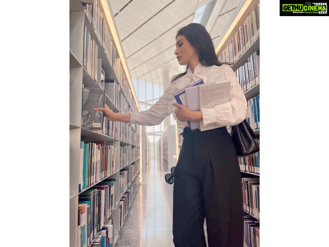 Mouni Roy Instagram - For some of us, books are as important as almost anything else on earth. What a miracle it is that out of these small, flat, rigid squares of paper unfolds world after world after world, worlds that sing to you, comfort and quiet or excite you. Books help us understand who we are and how we are to behave. They show us what community and friendship mean; they show us how to live and die….. In greatest company all morning.. the smell of books… aah!!!!! • • • Qatar is more than just beaches, good food and shopping. It’s a vibe with so much soul.. #QatarNationalLibrary @visitqatar Qatar National Library مكتبة قطر الوطنية
