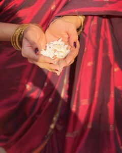 Malavika Mohanan Instagram - We have a lot of ‘mullapoo’(mogra) plants in our ancestral house, because it’s my mother’s favourite flower. Whenever she’s here, she has her tiny mullapoo routine. She steps out into our garden every evening with a small basket, and picks out the buds which are ready to bloom. She then strings them together, quite enjoying the whole process of it, and then keeps it next to the idol of a deity in the ‘pooja’ room. She wears it in her hair the next morning after the buds have bloomed, and sometimes even wears it in her hair while sleeping, saying that the mullapoo makes the hair smell beautiful the next morning. The soft, beautiful fragrance of the flowers wafts through the air when she walks around the next day.. This, in the picture, is one of those plants, and maybe an unmindful passing down of a personal tradition that a child picks up from a mother, unknowingly.. Payyanur, Kerala, India