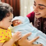 Pearle Maaney Instagram - One of the most beautiful relationships in the world is the bond between sisters and as I hold our little Baby Reign ( Pronounced as Rain ) in my arms… I feel like I’ve become a mother once again… when Rachel was in labour I was running around reliving all that discomfort wondering if my little sister would be able to handle the pain but Rachel was the strongest. Now the day we met Reign… I felt like we already had a strong connection… he definitely is the most precious and Nila just became a Big Sister. She first was a bit confused looking at him but with time she started saying “Vavooo” seeing him… I look at them and I see a wonderful sister brother relationship growing. Ruben mama is very close to Nila and Mema is her second Moma. I thank God for blessing Us with this little Angel… we treasure him and we waited so patiently for him to arrive. Filled with Gratitude and Peace. I will always be with them every step of the way… just a call away 🥰 . Now swipe Right and Guess what Nila is thinking 😀 @rubenbijy @rachel_maaney @nila.pearlish @srinish_aravind