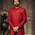 Santhosh Prathap Instagram – Deep red Sherwani with Asymmetrical Kurta. 
Can be customised to colour of your choice. 

Models: @santhoshprathapoffl @vekkey @kamurudin
Photo: @thevenkatbala
Creative & stylist: @jenson16
Makeup: @touchofandy
Menswear: #Singarajah
Production executive: @durai_making_moves_
Gaffer: @gopal_gaffer
.
.
.
.
.
.
.
.
#Singarajah #SingarajahMenswear #WearingSingarajah #TheMadrasGang #indianwedding #Groomwear #Menwithclass #Cocktailedit2022 #Santhosh #Sarpatta #SarpattaParambarai
 #Groomsofsingarajah #Bespoke #Madetomeasure #Sherwani #Kurtaformen #Tamilwedding #SingarajahShoes #Formalshoes #Veshti #Cocktailwear #Groomsinspiration