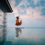 Rukmini Vijayakumar Instagram - Floating in air between the sky and water ….. I wish I led life like this photo…. Flying through everything with ease… :-) Photo @vivianambrose #jump #ocean #sky #bluesky #dancer #dancerlife #suspend #levitate #indiandance #indiandancer