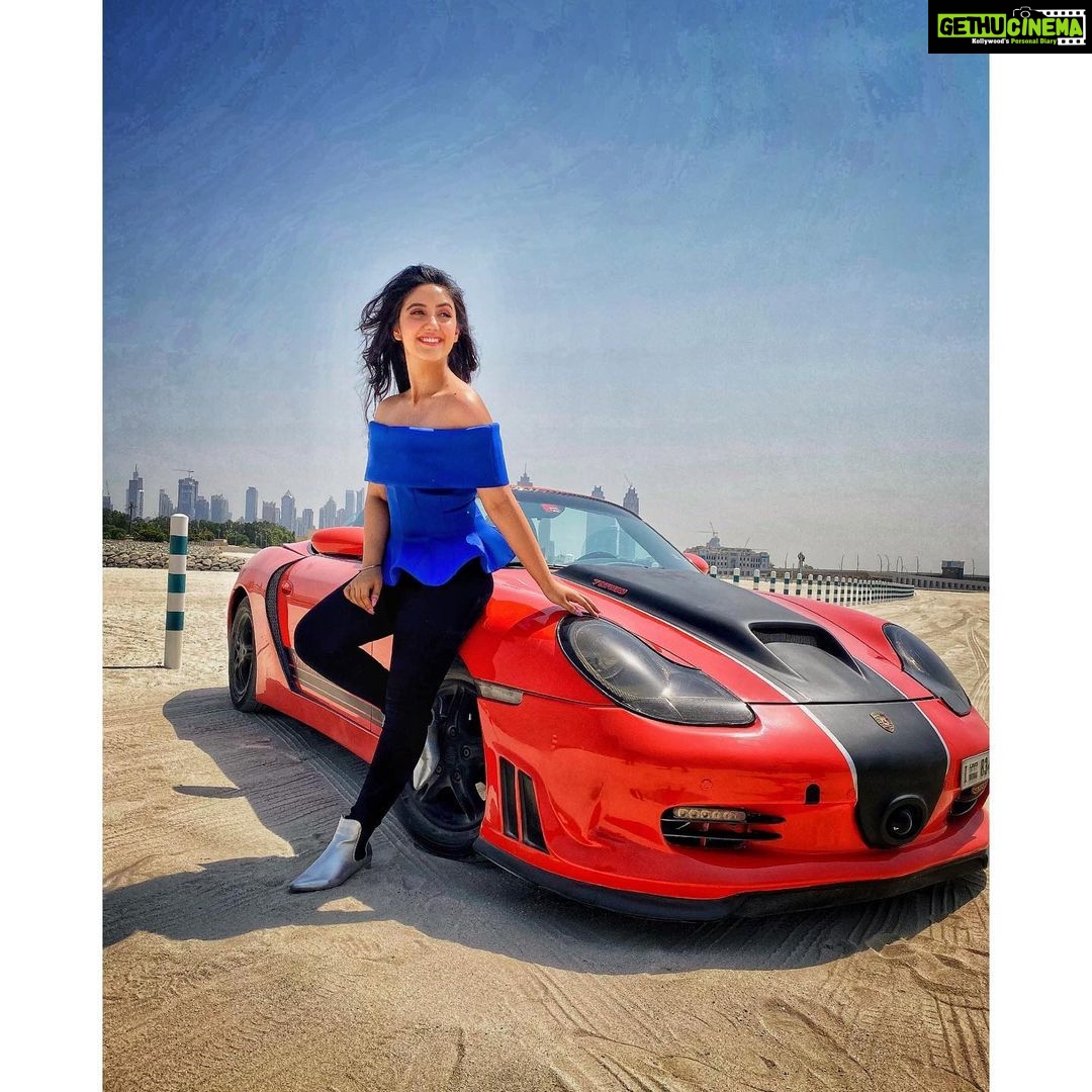 Ashnoor Kaur Instagram - Don’t sit at the passenger’s seat, Take the steering wheel of your life💙 . 1 or 2? . #DubaiDiaries #porsche #Lovemylife #lovemywork #actor #MeriGalti #AshnoorStyleDiaries #Blue #RedPorsche Styled by @dhartigulati Dubai, United Arab Emirates