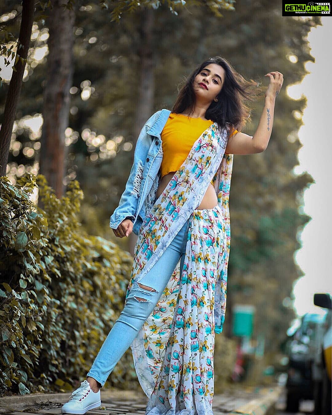 Deepthi Sunaina Instagram - Ditching the conventional style by giving a fun & modern spin to the traditional look by pairing saree with jeans, crop top & completing it with sneakers & a flashy denim jacket. Wear this to your best friend's sangeet to take on the contemparory vibe & go all out on the dance floor stress-free. Let me know what occasion would you prefer this look. Also, don't forget to check out @myntra fashionotasav collection to try out more options on my look. HURRY! Valid only until 15th of OCT - LINK In BIO. #MyntraFashionotsav #Myntra #LightUp #FestiveShopping #FestiveStyles . . . #galleri5InfluenStar PC: @mark_man_
