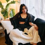 Neha Sharma Instagram - Another day, another slay… 👣🤍🖤 . . . Photography: @leroifoto Styling: @aeshah Shirt, trousers: @urvashikaur Top: @massimodutti Bracelets, rings: @myrhabyrhea Hair : @tejisinghofficial