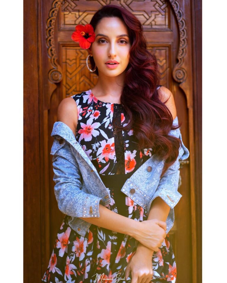 Nora Fatehi Instagram - Noriana extra AF with that flower 🌺 Styled by @marcepedrozo for the Annual Caftan 2019 press conference in Marrakesh 🇲🇦 Photo @mohamedsaadstudio Jacket @marcjacobs Dress @guess
