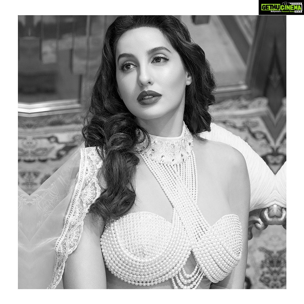 Nora Fatehi Instagram - Ancient Indian texts say the pearl was born when the Earth's Waters and Heaven's powers, mingled with a bolt of lightning. The Divine lustre and ethereal simplicity of pearls and crystals combine in this embroidered collared blouse to create a sensual masterpiece of bejewelled beauty. @abujanisandeepkhosla Abu Jani Sandeep Khosla for Nora Fatehi. Photographer: @virajnayar HMU: @namratasoni . . . #abujanisandeepkhosla #norafatehi #pearl #blouse #crystals #collar #organza #dakhai #kamdani #saree #resham #mandala #sequins #embroideries #textiles #textilesofindia #fashion #original #classic #techniques #fashionforwomen #luxury #couture #madeinindia #indiafantastique #abujani #sandeepkhosla