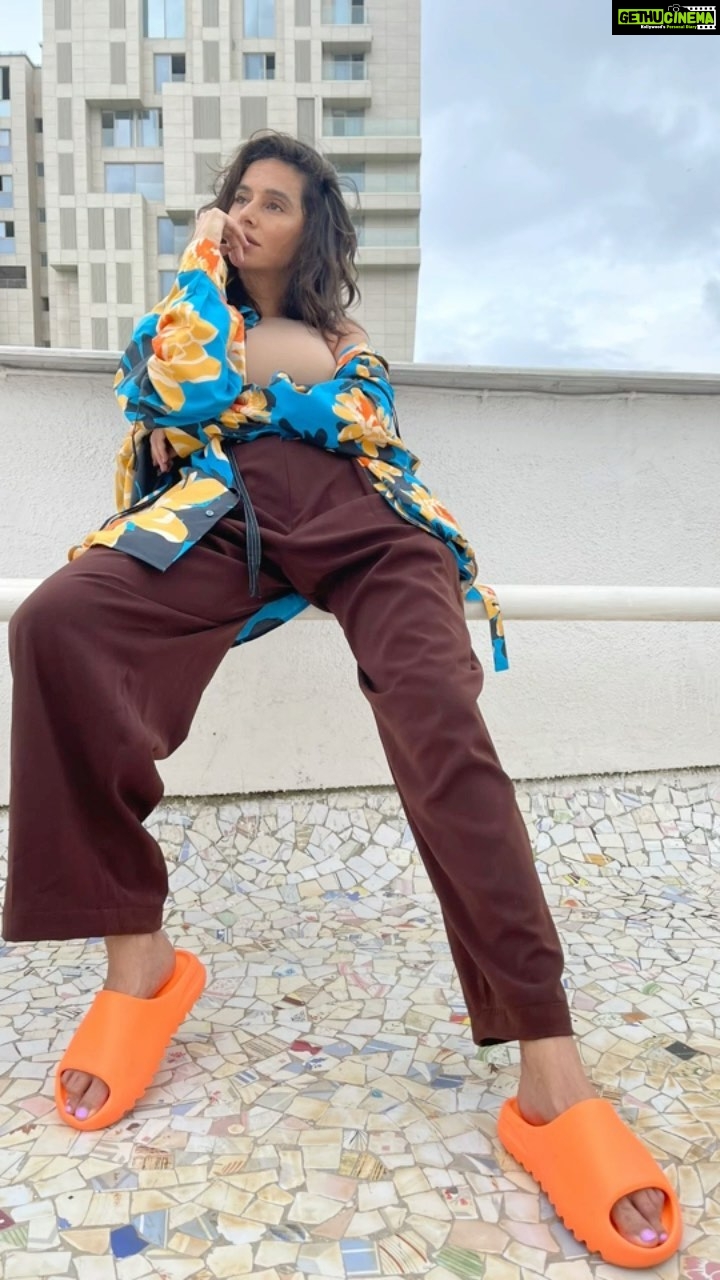 Shibani Dandekar Instagram - Current favs in fashion and music π§‘ππ€ printed shirted by @dhruvkapoor pants by @deme_love_ white shirt by @deme_love_ @gabriellademetriades bodysuit by @skims sneakers by @asicsindia @viviennewestwood slides by @yeezymafia #toduntaak @theeevil @dubsharma