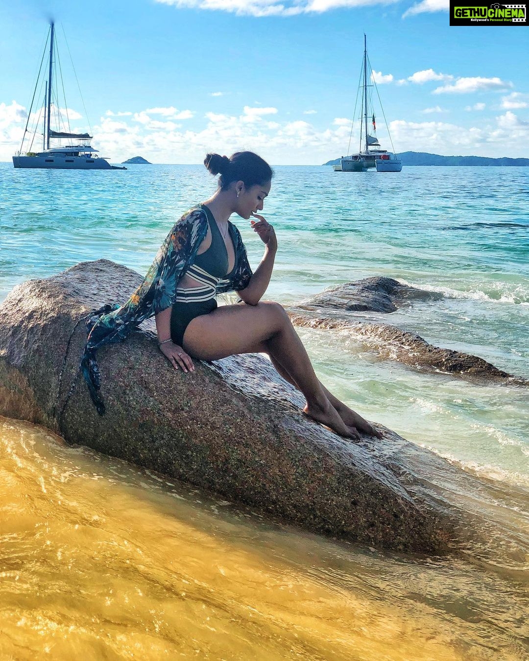 Tridha Choudhury Instagram - Looking back at the day when I almost drowned⭐️ Sharing a brief episode of How Life gave me a Second chance . I was enjoying a swim in #anselazio in Praslin, Seychelles, when a Rogue wave hit me and almost bashed me against a giant boulder. The salt water was choking me and blinding me at the same time; in an attempt to gasp for air to breathe, I started throwing my limbs in every direction possible, to get an anchor. The waves kept hitting me against the boulders and I thought to myself... This is it... What a beautiful way to die. Nobody could see me or hear me as I had drifted away from the beach. My struggle for air didn’t go unnoticed , I somehow managed to find a small boulder with a crevice that was wide enough for me to hold onto . My Adrenaline encouraged me to surface and I lay on a giant boulder facing the sky. The only words that escaped my mouth as my breathing normalised were- Thank you Universe ⭐️- #misstriouslyyours Life gives you multiple chances. Never take them for granted. Cherish those Chances and Thank the Universe for keeping you Alive and Happy⭐️ Please share this with anyone Who does not Believe in Second Chances⭐️ P.S- This image was clicked hours later, when I had the courage to regain my strength and ask a local to capture me⭐️ @chefnight @_fudgemenot @themountainmonk_ @reshmabhattacharya @neildas2020 @trishnachoudhury @roopangi_vakharia @pablodutta ⭐️ #secondchances #feelitreelit #thankyouuniverse #lockdown2020 #survivor2020 Anse Lazio