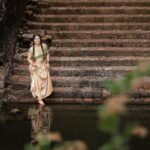 Rachana Narayanankutty Instagram - Pattu Pavada💚🧡 Graced in colours of apple green and pears combined in sentamizh pattu pavada. Ornamented with exquisite weaving of white and green beed string to endure her tenderness. The Tamil cult tradition of glints glass bangles coloured in green and red. PC @nithinznith_photography_ MUA &Styling @styledby_nami Fabric @pothysofficial @pothyssuperstoreskochi @pothyskerala #pattupavadai #pattupavada #tamil #tamilculture #kuppivala #rachananarayanankutty