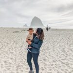 Richa Gangopadhyay Instagram - Here's another reason to add Oregon to your #bucketlist: The Oregon coast! Of the many gorgeous coastal beaches and towns in this state, one of our most frequented ones (especially when anyone comes to visit us!) is Cannon Beach 🌊. The iconic Haystack Rock 🪨 is accessible right from the beach and is an easy, 1.5 hour scenic drive from Portland metro. Cannon Beach has a quaint beach town bustling with saltwater taffy shops (with the wildest flavors!), people window shopping in charming little souvenir shops, loads of breweries, bars and restaurants surrounding a serene coastal residential area nestled in evergreens, mountains and a misty fog all year round (thanks to its own microclimate). You might get lucky on a rare sunny day, but it wouldn't be a Pacific Northwest experience without a little nip in the air! 🏔 We last brought Luca here when he was 8 months old, in a baby carrier, and now at 16 months all he wanted to do was chase his reflection in the glassy sand and fearlessly run into the ocean! Pictured: tiny human alone, dangerously close to the ocean; Not pictured: outgoing tide and 3 adults close by, constantly chasing him! 🌊 Cannon Beach never disappoints- make sure to save it for your visit out to Oregon! 💚 • • • • • #cannonbeach #oregoncoast #pacificnorthwest #pnwbeach #haystackrock #portland #oregon #oregonexplored Cannon Beach, Oregon