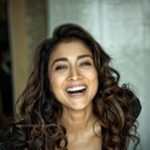 Sunder Ramu Instagram - In all the shoots I’ve done over the years there are always those moments when the person I’m shooting let’s their guard down. Where it’s not about the image they are trying to create or protect. I love those the most. With @shriya_saran1109 I’m amazed by the energy and vibe around her. She can slip into innocent, oomphy, girl next door or diva with so much ease in front of the camera. But she has also always had this quality of unbridled , unhindered, uncensored and untrained Joy that she excudes that’s so infectious. Wether it’s dancing on the streets of Barcelona or art galleries in europe. soaking in the sun on the sands of gorgeous beaches or gliding under the surface of the ocean in scuba gear. She makes everything look so effortless and fun. I love this image of her literally bursting with laughter. Unbound joy is a gift to be treasured. #sunderphotography @sunderramu