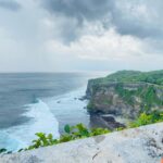 Surabhi Santosh Instagram - Uluwatu Temple was the last stop in my two week trip. It is definitely a must go! A walk through the scenic cliff during sunset just fills your soul. The cliff and sea beneath gives you a Varkala feel but the naughty and thieving monkeys will quickly make you realize that you are not in Kerala. And I’m not joking when I say that those monkeys will steal everything, from the specs resting on your head to your footwear if you leave it around, wallet and even your phone so saving your stuff from them takes a lot of effort and is an adventure in itself 😂 SWIPE LEFT #Balistories #uluwatutemple #traveltips #scenicbeauty #adventure #laughs Uluwatu Temple, Uluwatu, Bali